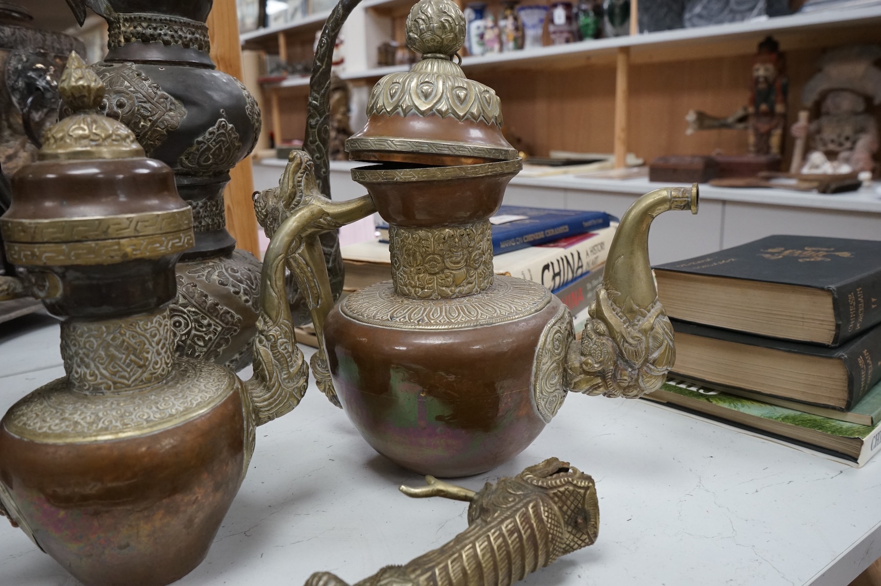 A collection of Asian embossed metalware, largest 41cm high